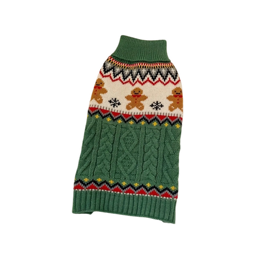 Green knitted dog sweater with gingerbread design on a beige background